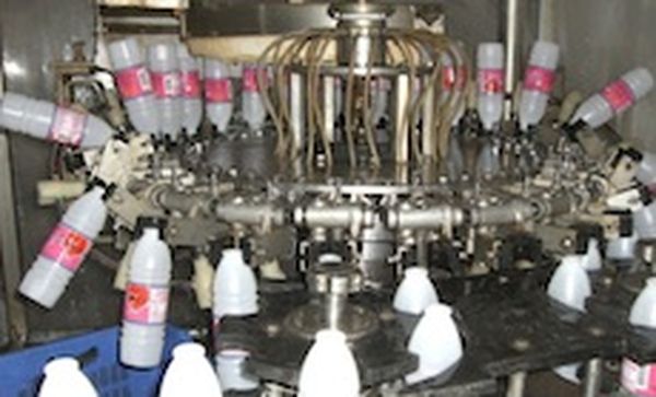 Clean bottles by inverting them and injecting with water